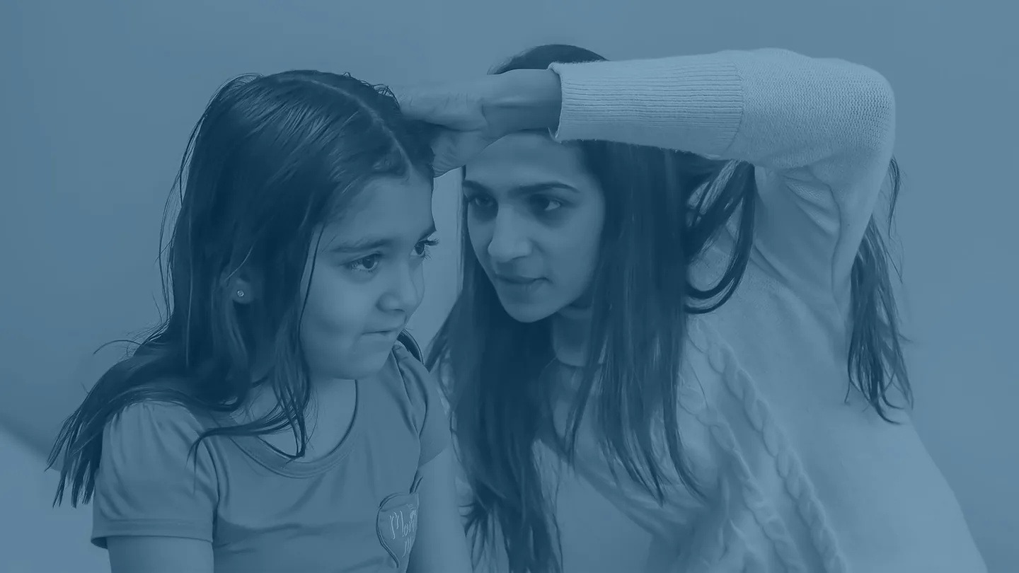 Physician gently examining a young girl at JioMed Family Care primary care clinic