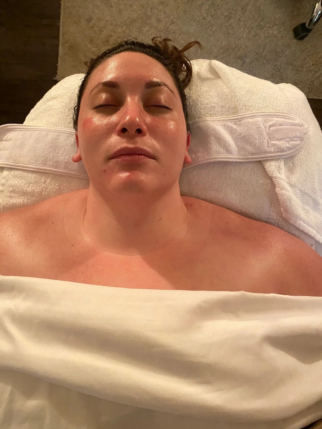 Client receiving facial serum during a spa treatment