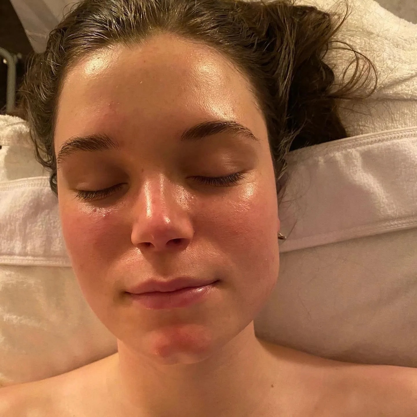 Client with glowing skin after a facial treatment