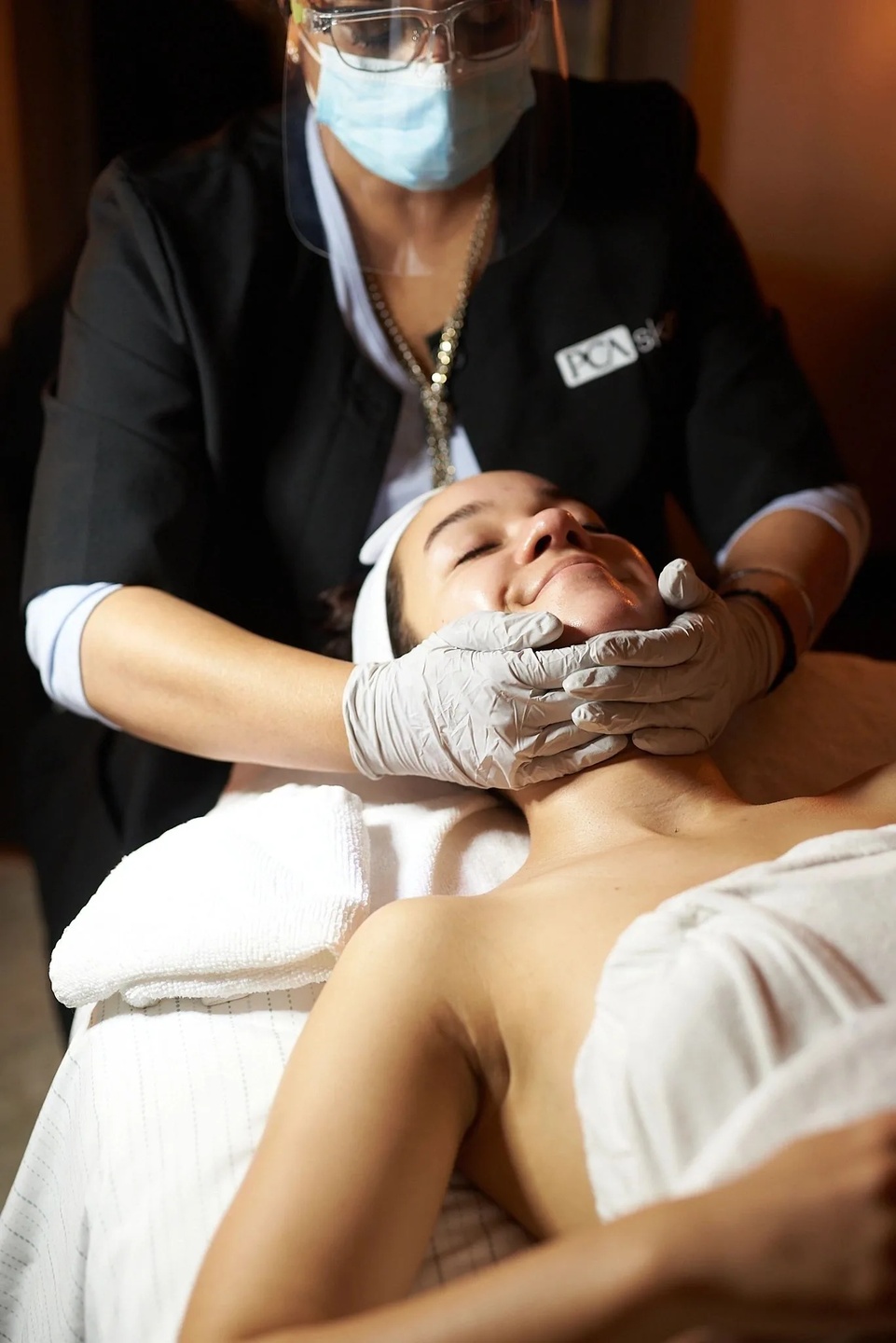 Facial massage treatment with face shield safety protocol