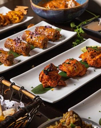 Spread of Hyderabad House grilled meats and platters