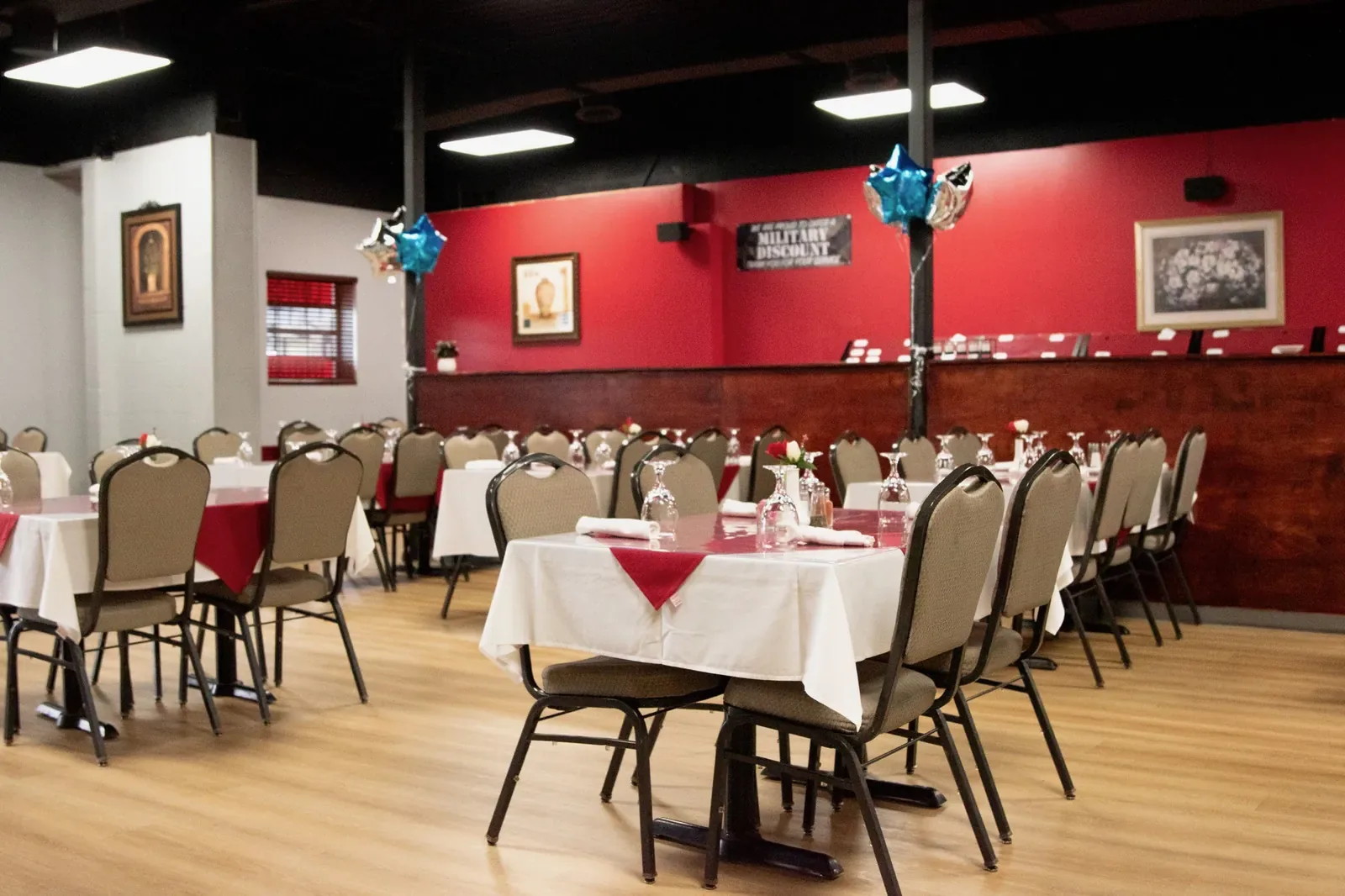 Curry and Grill dining room with set tables and red accent walls