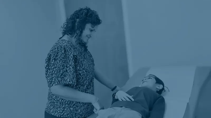 Physician gently examining a young girl at JioMed Family Care primary care clinic